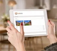 hands holding a tablet with reaforms on screen